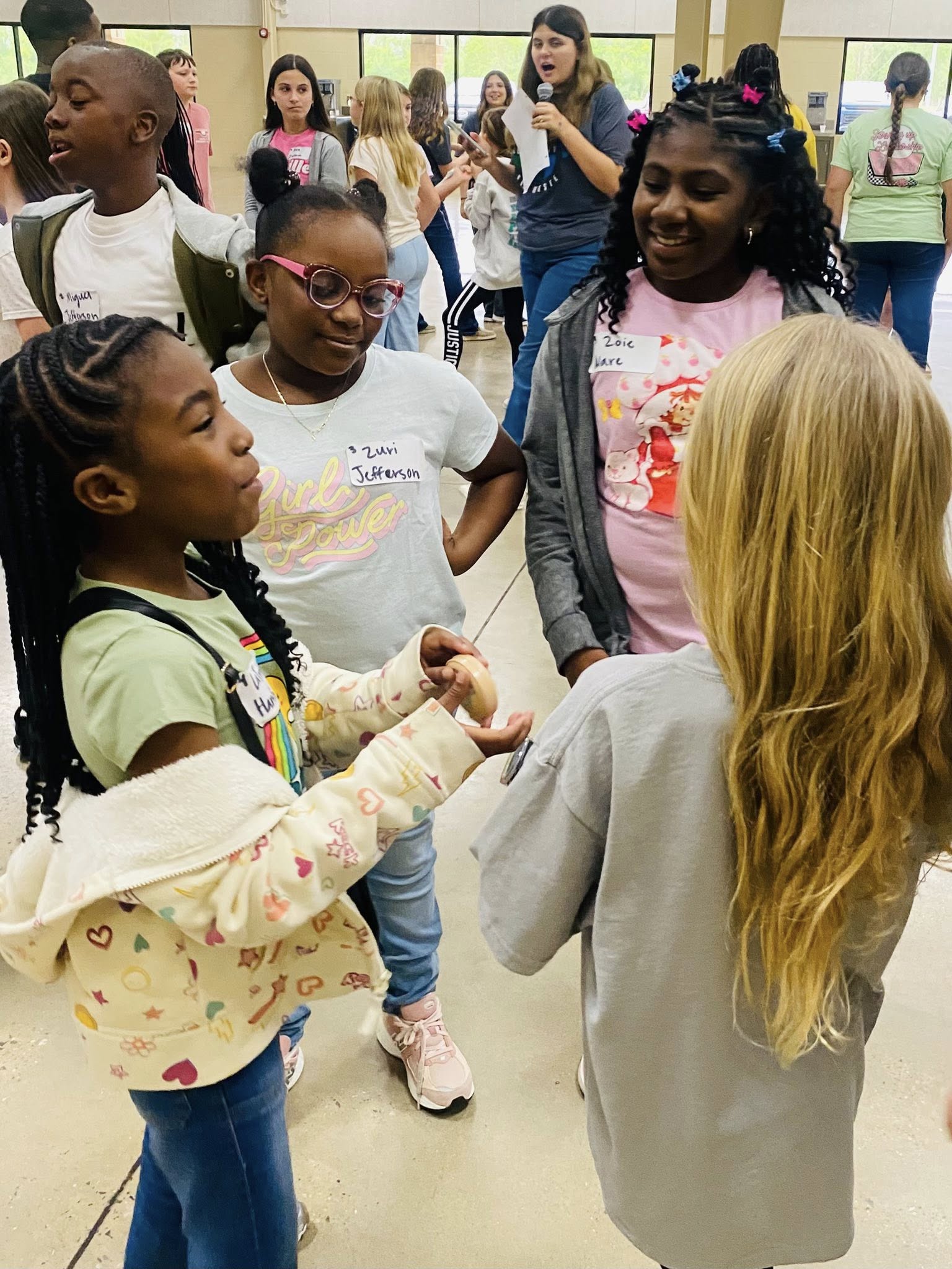 Four girls standing in a circle.